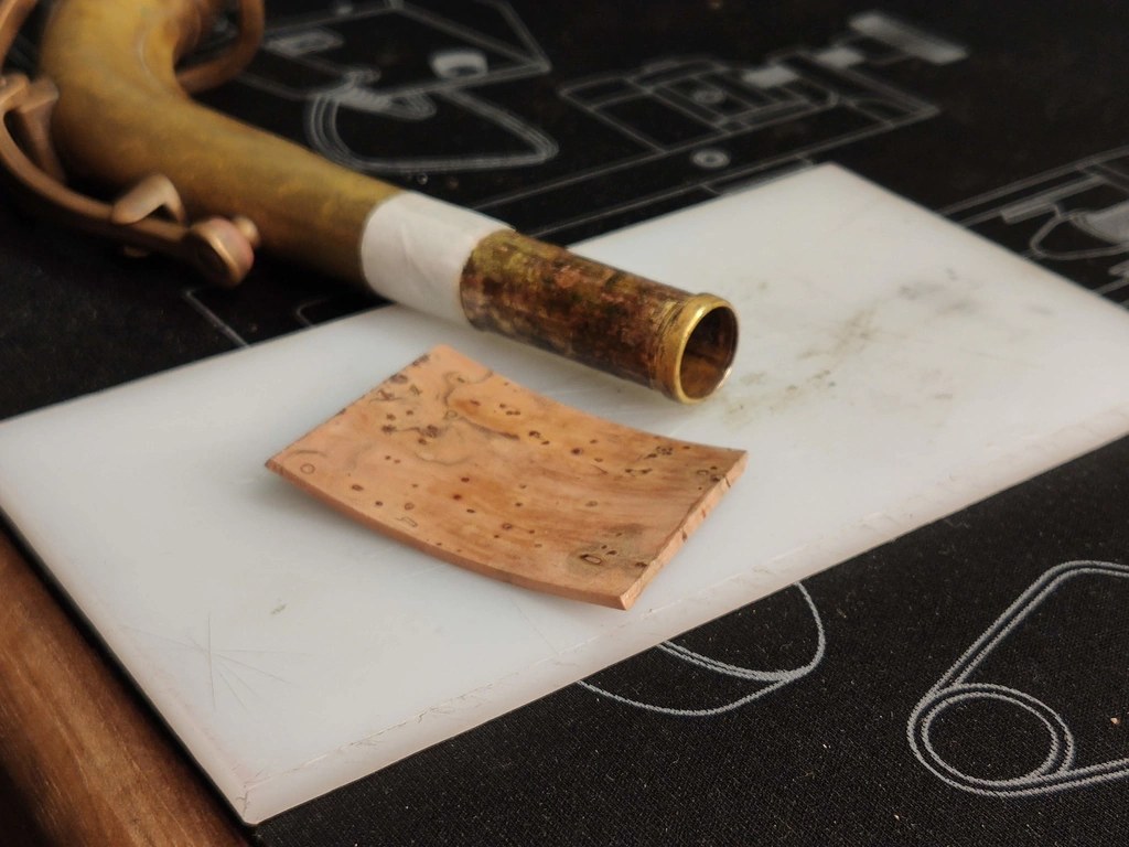 Cork sheet next to a saxophone neck